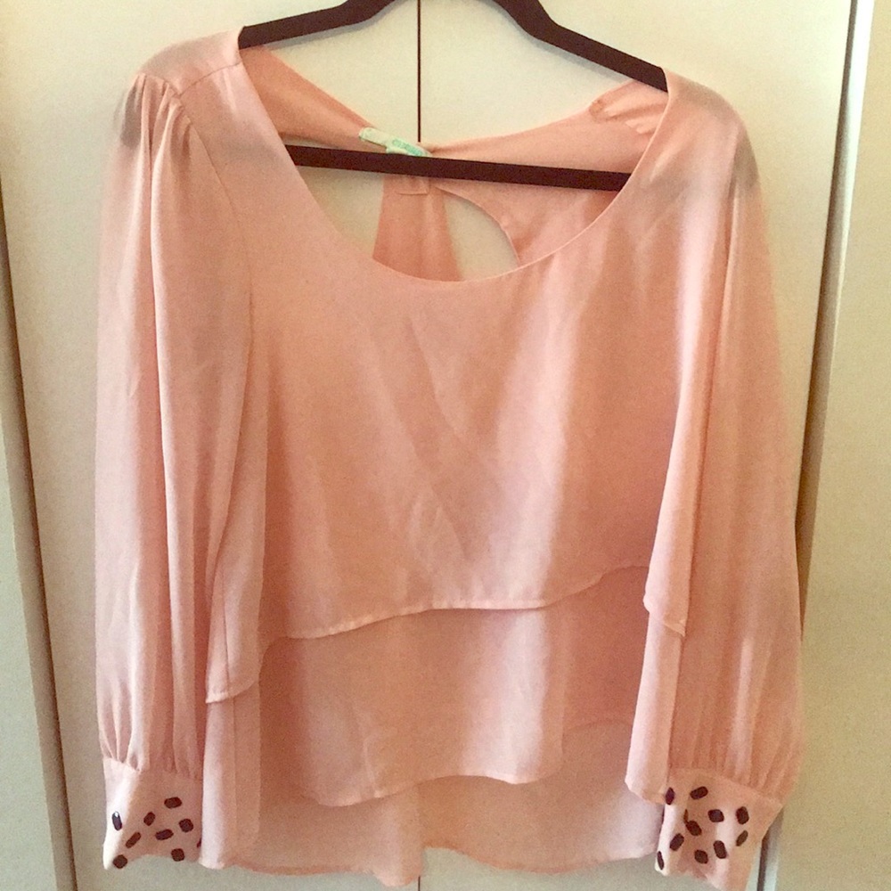 Medium pink shirt with embellishments on the cuffs